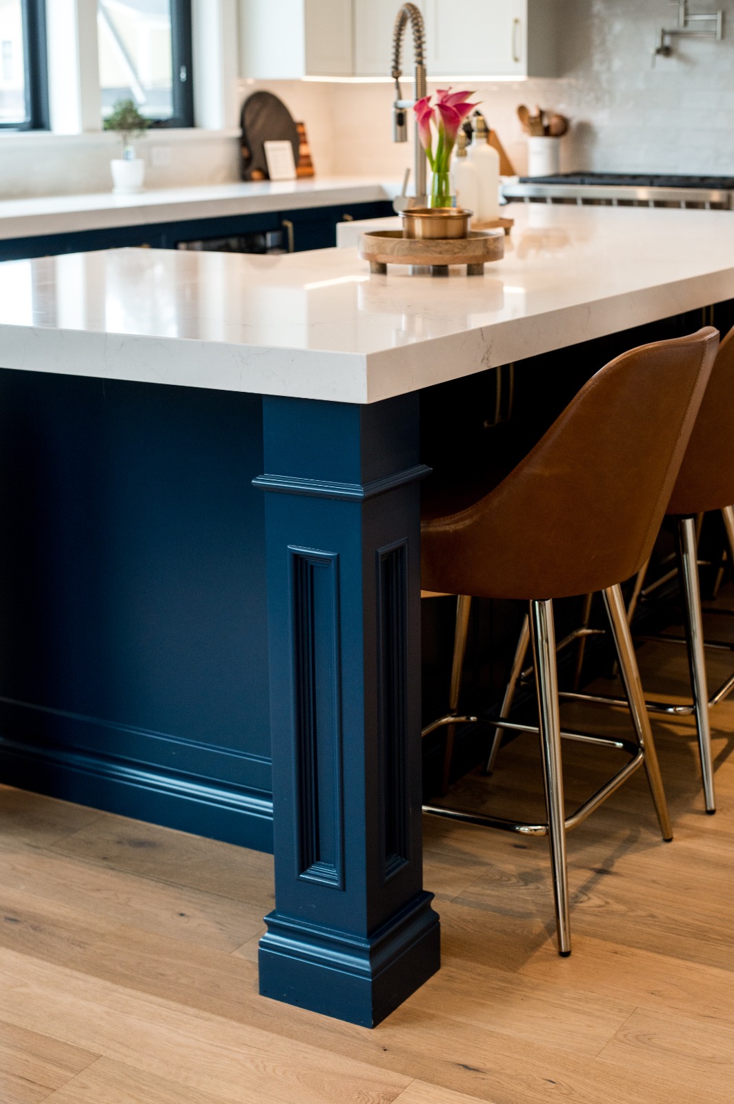 Custom kitchen island with black dome pendants and quartz countertop